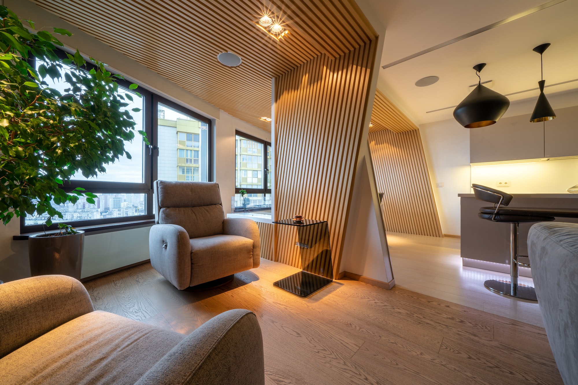 Luxury studio apartments in wooden colors with soft armchairs